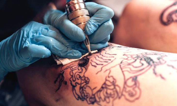 Tattoo Artist Making A Tattoo On A Shoulder