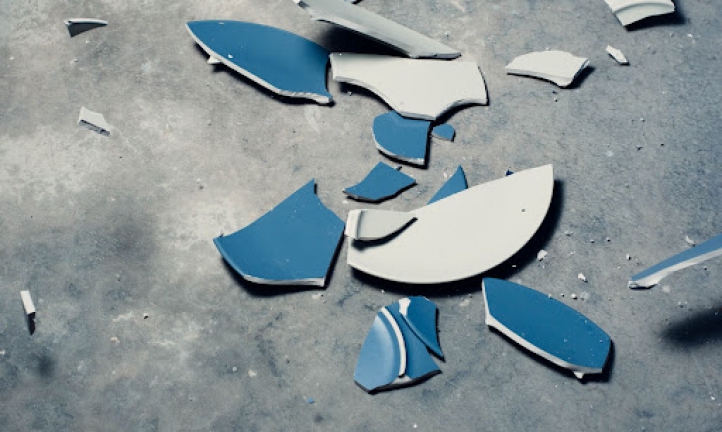 Blue plate smashed into pieces.