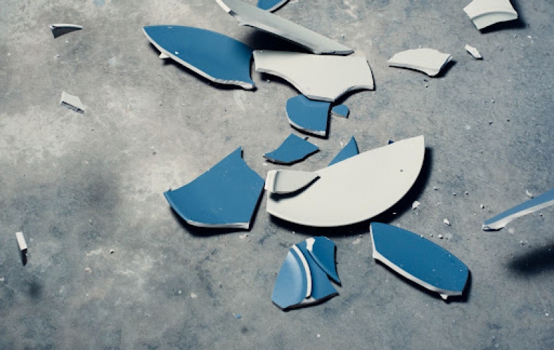 Blue plate smashed into pieces.