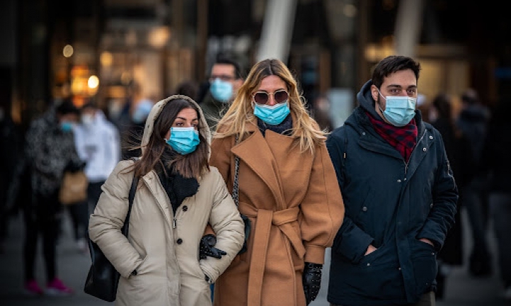 Group of people wearing COVID-19 face masks