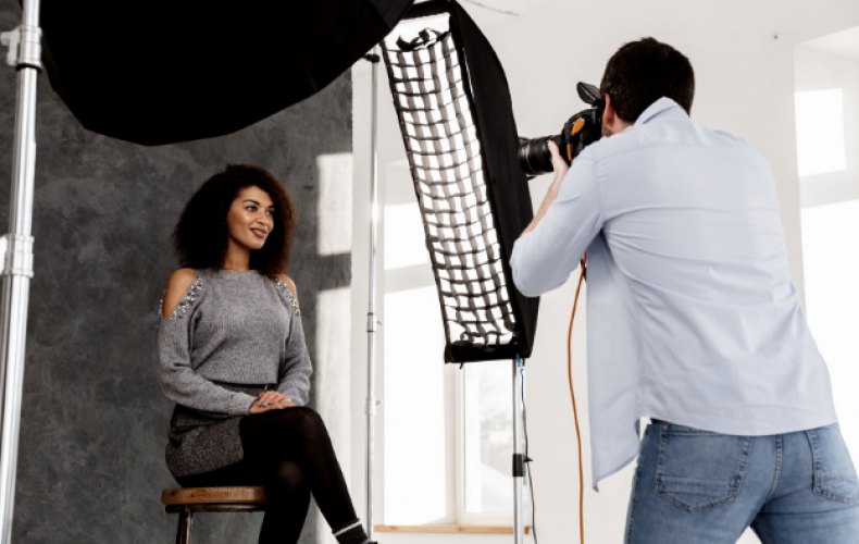 male photographer clicking model pictures in photo studio