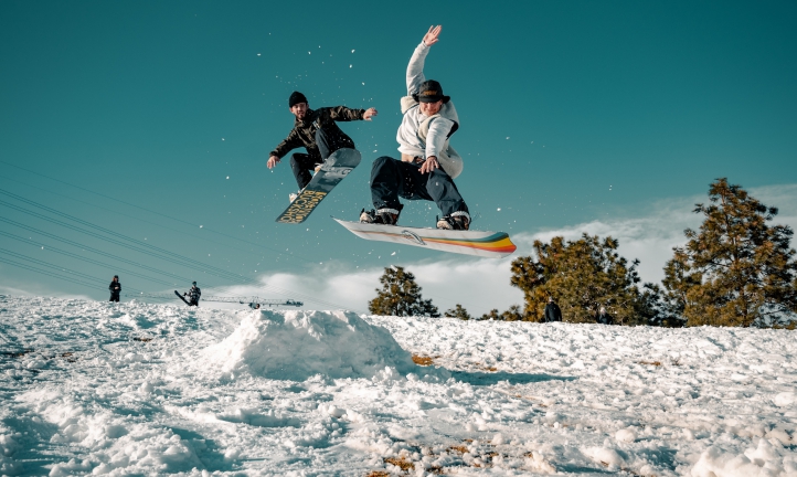 two people snowboarding