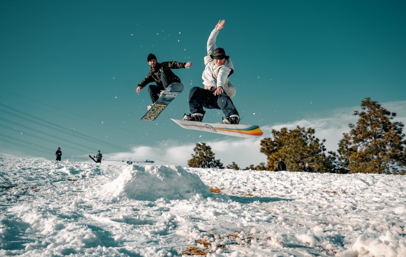 two people snowboarding