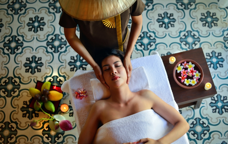 a woman giving head massage to another woman